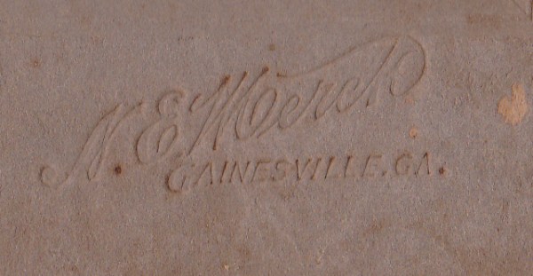 Merck, N.E. photo mat mark