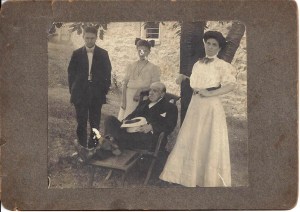 J. F. Coonley surrounded by his family, ca. 1910-1911. His daughter Ada Bell Coonley-Davis is on the right, on the left are his two grandchildren - the girl is Alva Davis (married name Vanderbeck); photo possibly taken by Elwood Charles Davis; from the Coonley family collection held by P.J. Vanderbeck-Thomas.